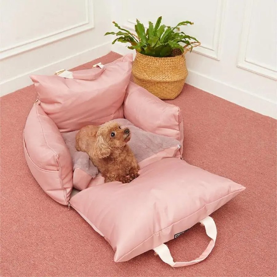 Poodle curled up in a blush pink DockSeat used as a bed at home