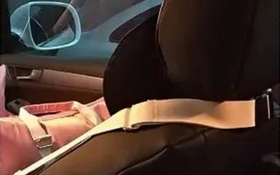 DockSeat strap looped around a car headrest